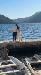 Couple photographed during sunny afternoon in historic Perast, Montenegro