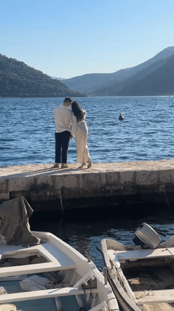 Couple photographed during sunny afternoon in historic Perast, Montenegro