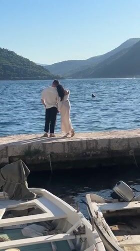 Couple photographed during sunny afternoon in historic Perast, Montenegro