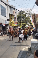Traditional street parade rolls through Malang with dancers and elephant float