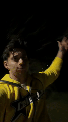 Man in yellow Celest hoodie points skyward in Bulgaria