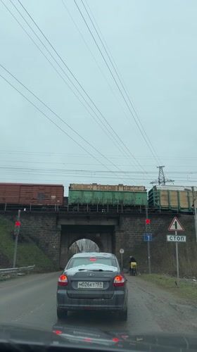 Family waits at railroad crossing in Froly, Russia