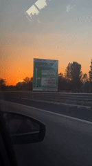 Driver captures vibrant sunset on Rome highway