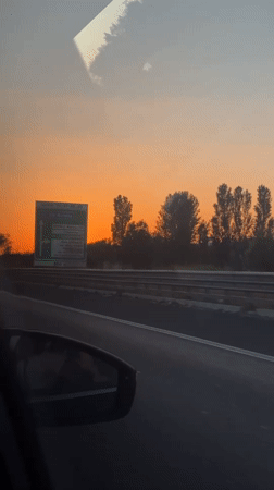 Driver captures vibrant sunset on Rome highway