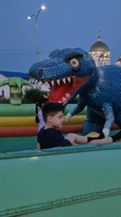 Sunset at a Kokshetau lakeside promenade with inflatable playground