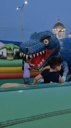 Sunset at a Kokshetau lakeside promenade with inflatable playground