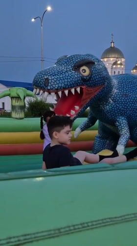 Sunset at a Kokshetau lakeside promenade with inflatable playground