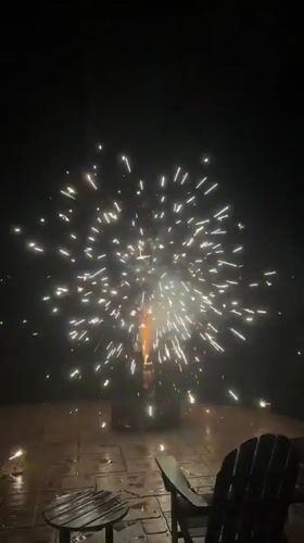 Backyard fireworks light up a stone patio in Mineral, Virginia