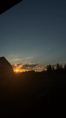 Summer sunset over a quiet Ukrainian village, with everyday details.