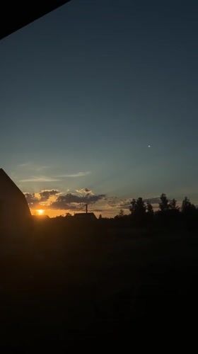 Summer sunset over a quiet Ukrainian village, with everyday details.