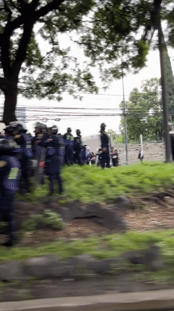 Riot police form line facing civilians in Mexico City