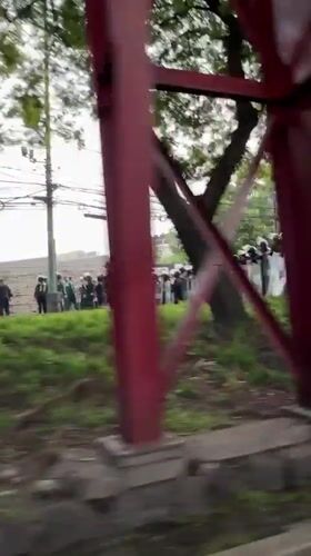 Riot police form line facing civilians in Mexico City