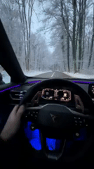Driver navigates snowy Luxembourg roads in modern vehicle