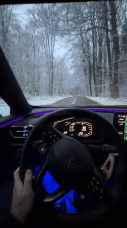 Driver navigates snowy Luxembourg roads in modern vehicle