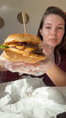 Woman enjoys burger lunch at KP Burger in Belgrade