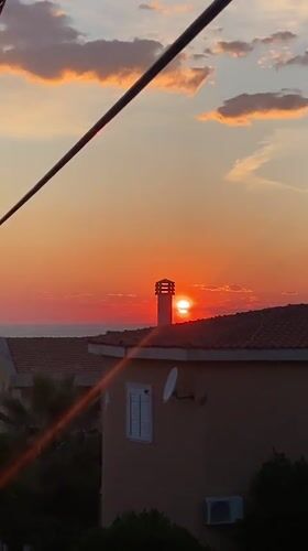 Woman documents sunset moment in coastal Montenegro village