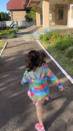 Child plays at Ukrainian village playgrounds during morning hours