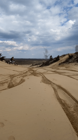 Dirt bike rider navigates sandy dunes in Belarus