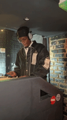 DJ mixing music in dimly lit London venue