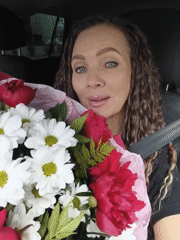 Woman receives flower bouquets during morning urban outing