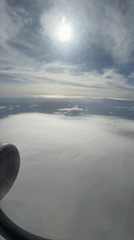 Passenger films sunny aerial view over Montenegro cloudscape