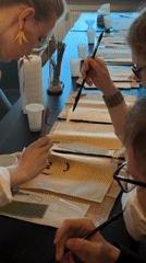 Brush calligraphy workshop in progress at an Omsk indoor venue