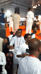 Large white-clad gathering held under decorated tent in Kubwa