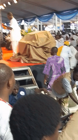 Large white-clad gathering held under decorated tent in Kubwa