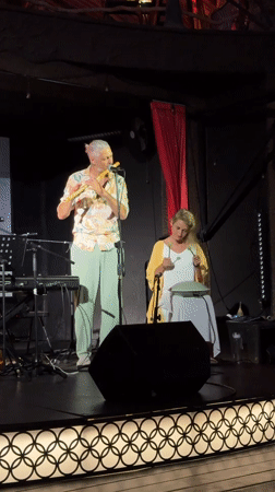 Intimate world-music stage performance with eclectic mix of instruments