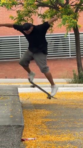 Barcelona street life: skateboarders, trams, architecture amid yellow petals
