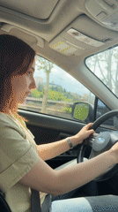 Red-haired woman drives Subaru through central Tbilisi