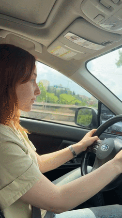 Red-haired woman drives Subaru through central Tbilisi