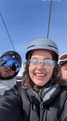 Skiers enjoy sunny chairlift ride in Courchevel mountains