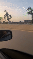 Driver documents golden hour street scenes in Abuja