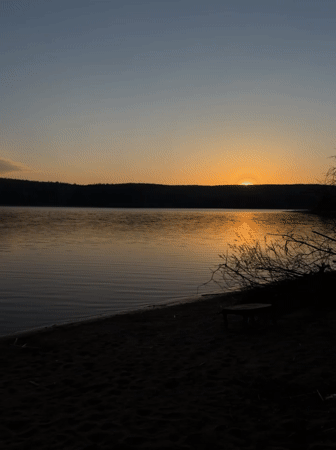 Sunset fishing setup captured at Chaykovsky lakeside beach