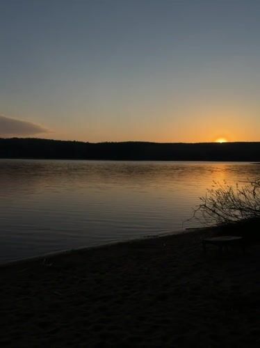 Sunset fishing setup captured at Chaykovsky lakeside beach