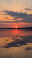 Sunset over water captured by witnesses in Chaikovsky, Russia