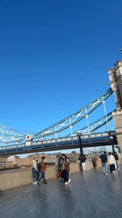 Clear skies, pedestrians enjoy Tower Bridge promenade walk
