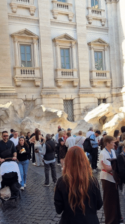 Crowds gather at Rome's Trevi Fountain on sunny afternoon