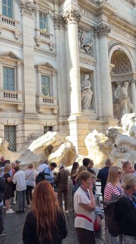 Crowds gather at Rome's Trevi Fountain on sunny afternoon