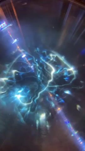 This media file is a short video clip showing a close-up, abstract view of swirling blue and white lights. The lights appear to be in constant motion, creating a dynamic and somewhat ethereal effect. It's difficult to discern specific objects or a clear scene, as the focus is on the light patterns and their movement. The overall impression is one of energy and fluidity. There are no discernible people, specific objects, or clear setting details. The activity is purely visual, focusing on the play of light. No text is visible in the clip. The time of day, weather, and location cues are not apparent, and the emotions evoked are open to interpretation due to the abstract nature of the visuals. The Three Rivers, United Kingdom location context does not offer any visual clues within the media itself.