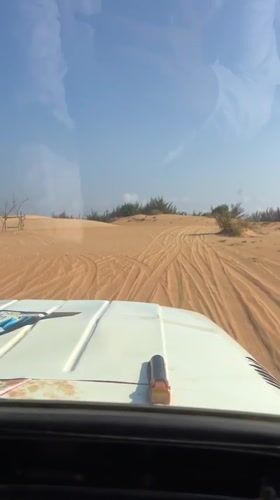 Vehicle passenger captures sand dune vista in Phuoc Dinh