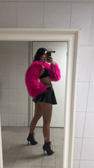 Woman takes mirror selfies in pink jacket in Kazan