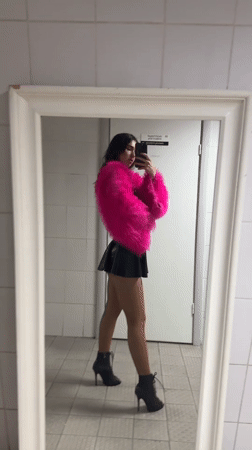 Woman takes mirror selfies in pink jacket in Kazan