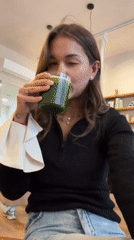 Woman enjoys café refreshments, takes selfies in Lyon establishment