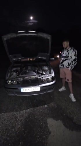 Car breakdown attended to by two men in Pushevo