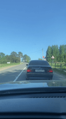 Car waits at railway crossing in Chaikovsky, Russia