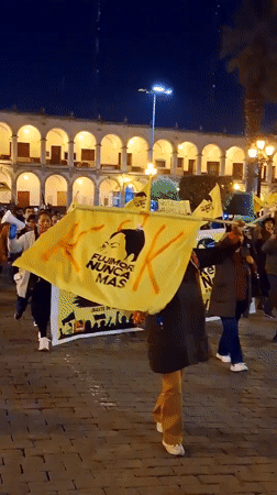 Nighttime protest with yellow banners documented in Arequipa, Peru