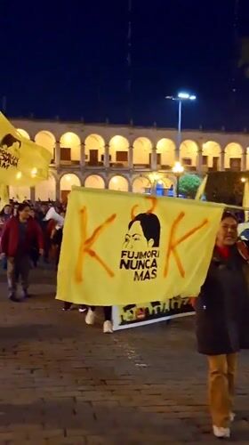 Nighttime protest with yellow banners documented in Arequipa, Peru