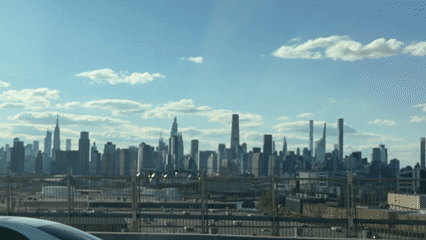 NYC skyline viewed from elevated position amid clear skies